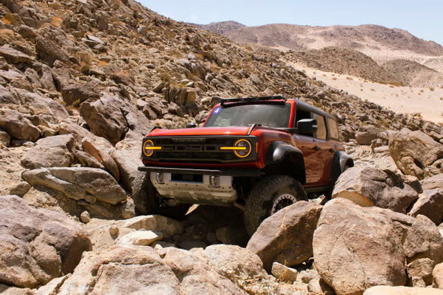 red Ford Bronco Raptor rock crawling