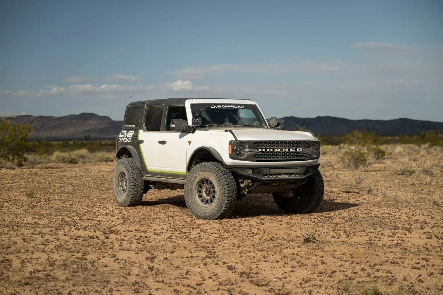 Picture of a Ford Bronco in a sandy field with a DV8 front bumper