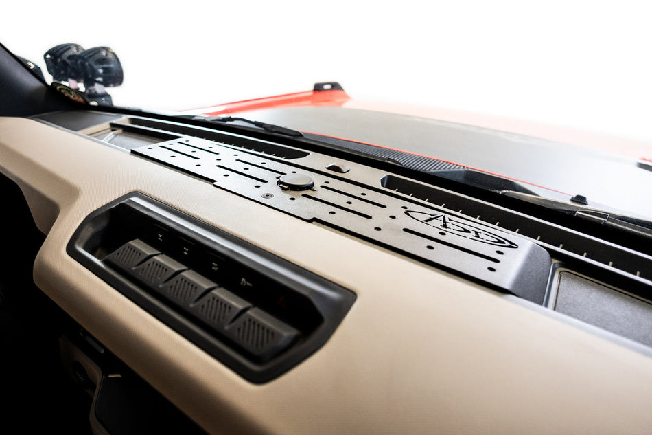 Close-up of a Ford Bronco's dashboard with device dash mount branded with Addctive Desert Designs