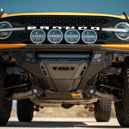 DV8 Offroad FBBR-08 Tube Series front bumper installed on yellow Ford Bronco with round lights – front three-quarter