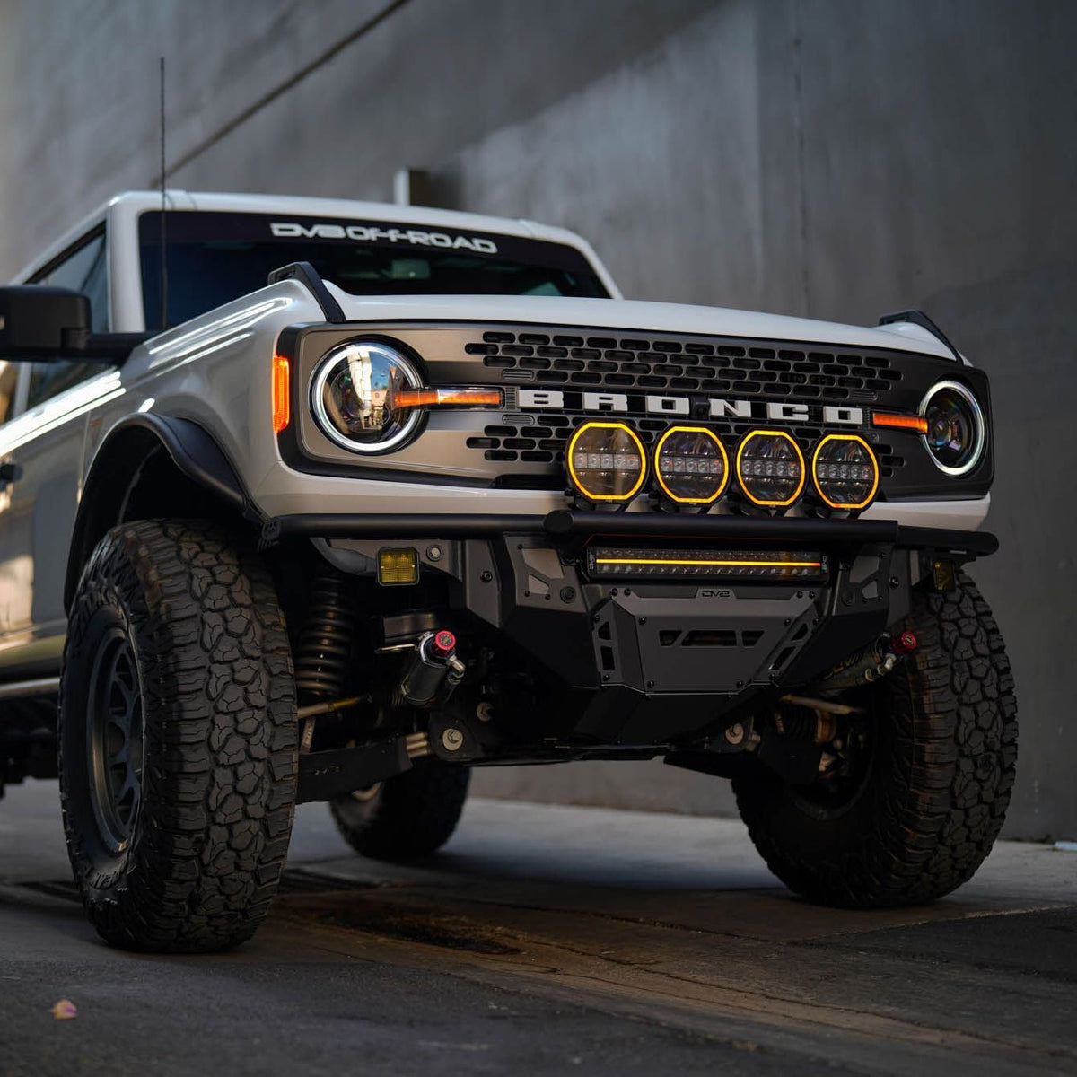 Ford Bronco truck parked on a street with a building in the background