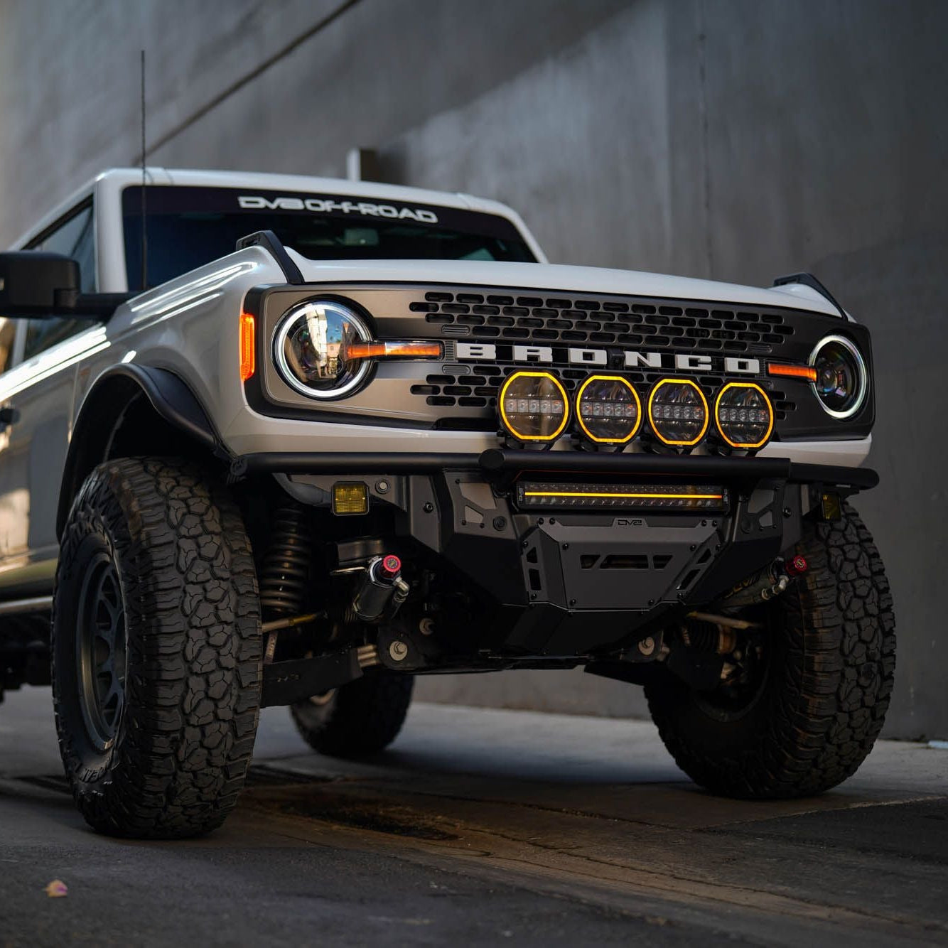 Ford Bronco truck parked on a street with a building in the background