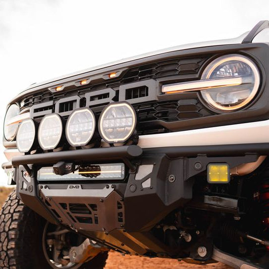 DV8 Offroad Tube Series front bumper close-up installed on Ford Bronco Raptor showing light mount tabs and grille
