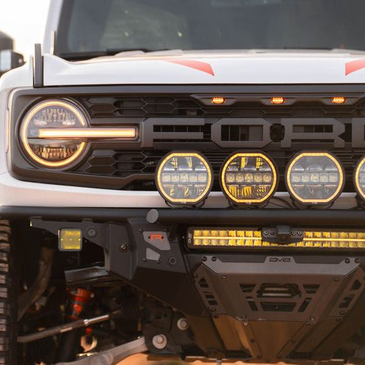 DV8 Offroad Tube Series front bumper installed on white Ford Bronco Raptor with round auxiliary lights – trail shot