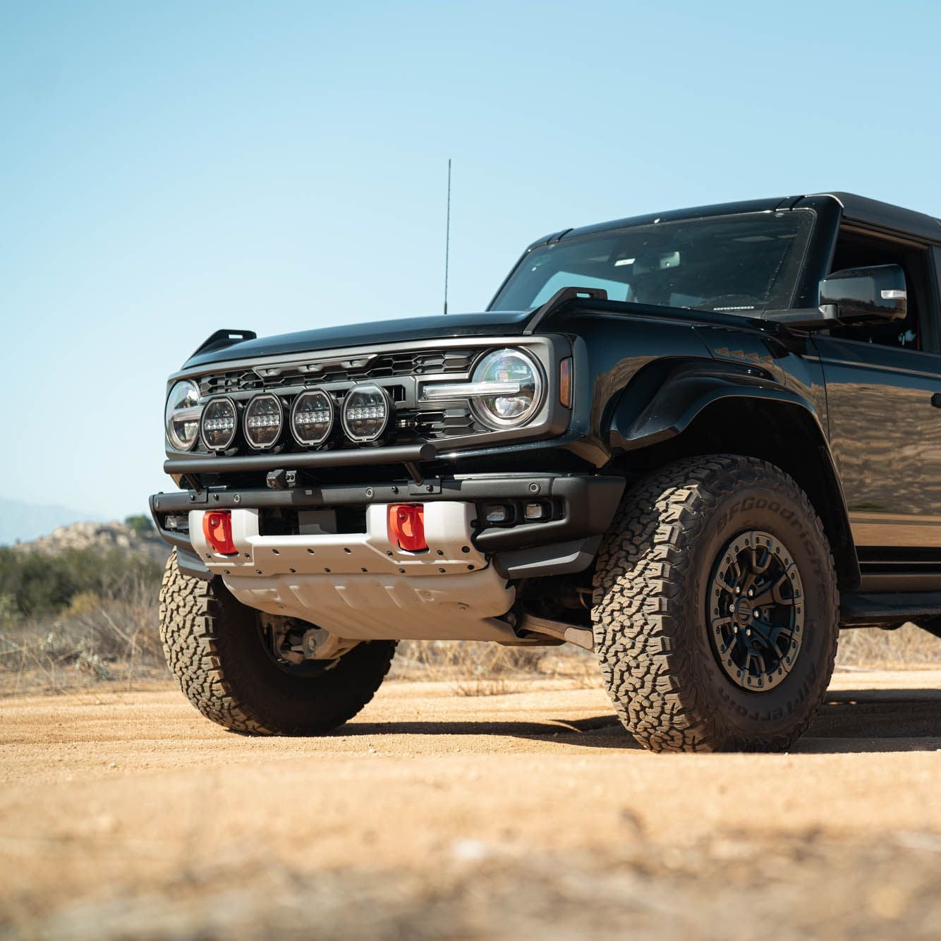DV8 Offroad LBBR-10 Tube Push Bar installed on black Ford Bronco – front three-quarter low angle desert