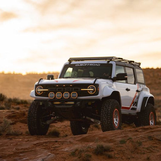 DV8 Offroad Tube Series front bumper installed on white Ford Bronco Raptor – side profile desert sunset
