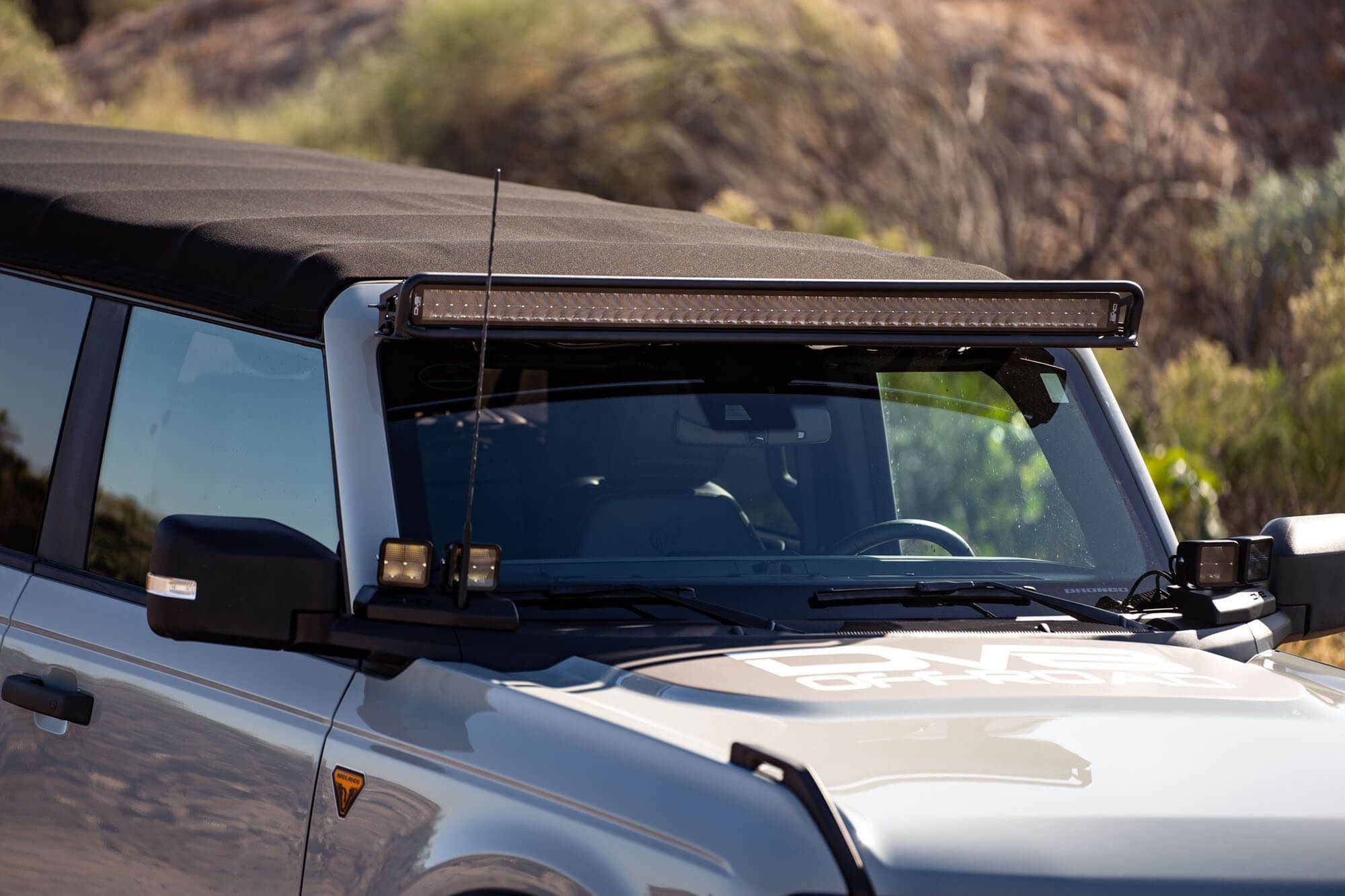 DV8 Offroad 52-inch straight light bar mount installed on 2021-2026 Ford Bronco side view showing bar above roofline