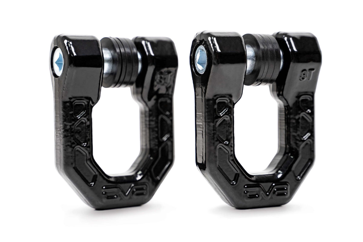 Two black D-ring shackles slightly angled away from the camera on a beautiful, professional white background