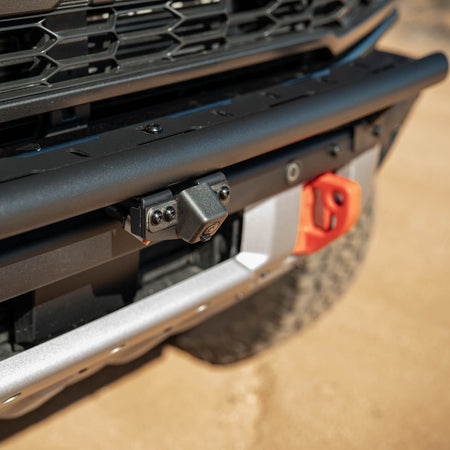 DV8 Offroad LBBR-10 Tube Push Bar installed on black Ford Bronco Raptor showing orange recovery points – close up front