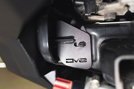DV8 Offroad frame horn reinforcement bracket installed on Ford Bronco frame, close-up showing DV8 logo, alternate angle