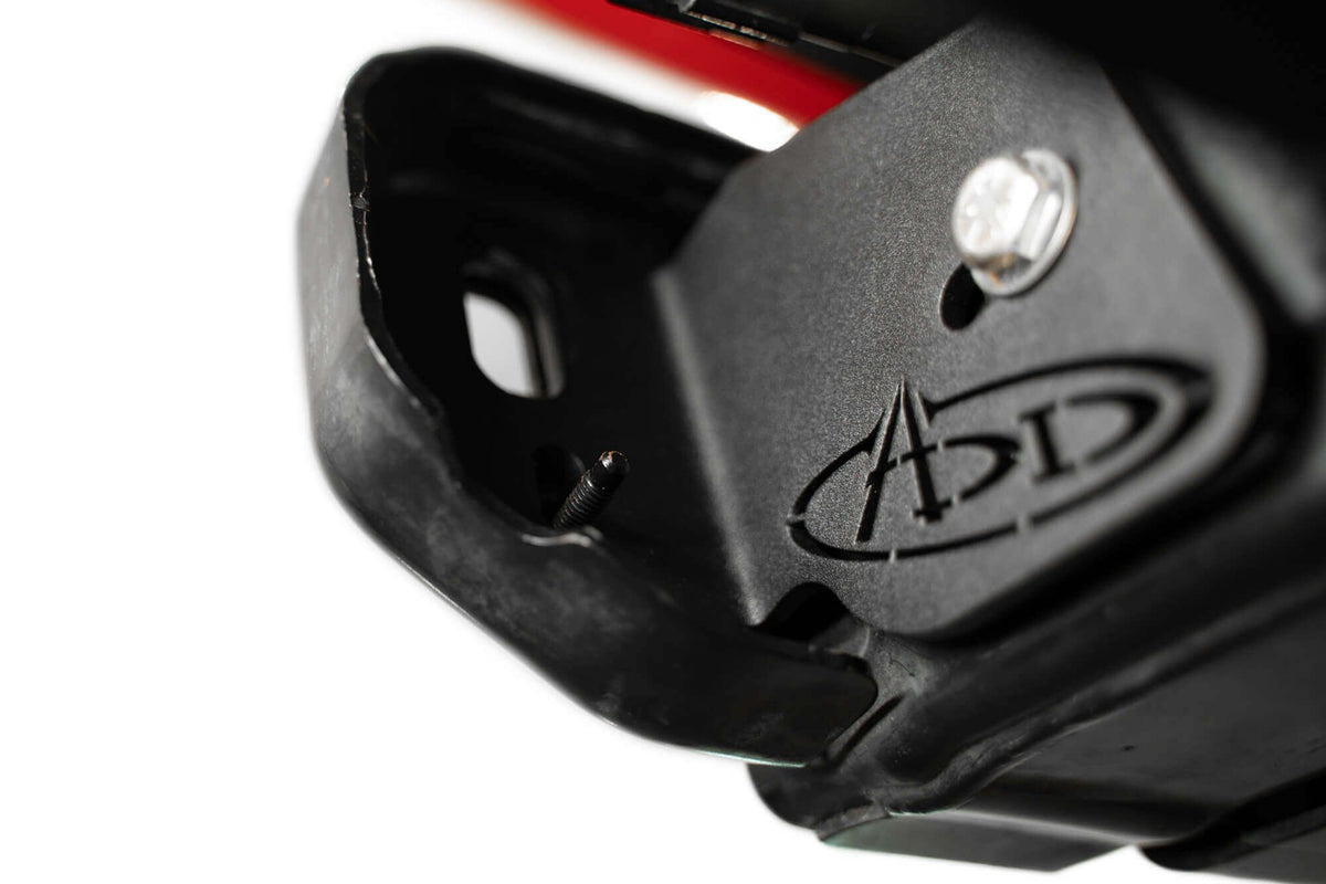 Addictive Desert Designs frame horn gusset installed on Ford Bronco frame, angled close-up showing ADD logo and bolt