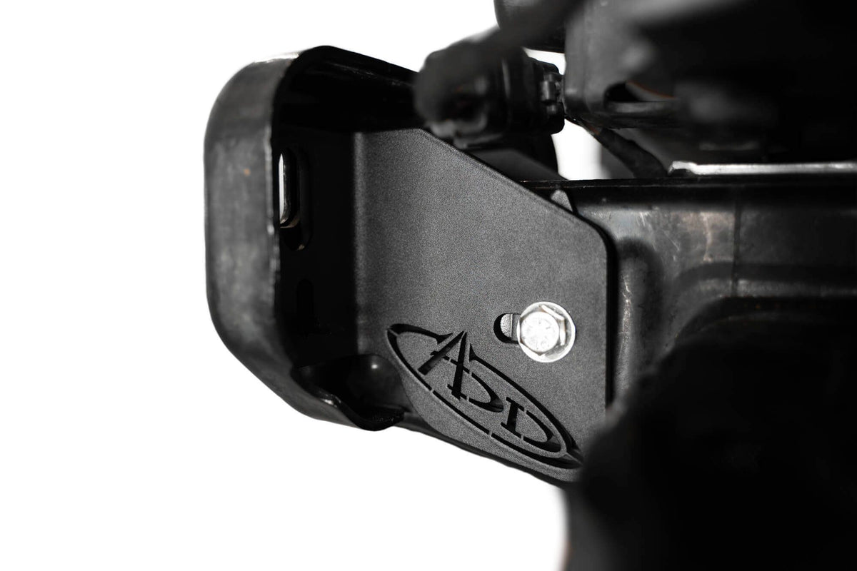Addictive Desert Designs frame horn gusset installed on Ford Bronco frame, close-up showing ADD logo and mounting bolt