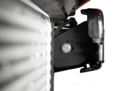 Addictive Desert Designs frame horn gusset installed on Ford Bronco frame, close-up near headlight reflector housing