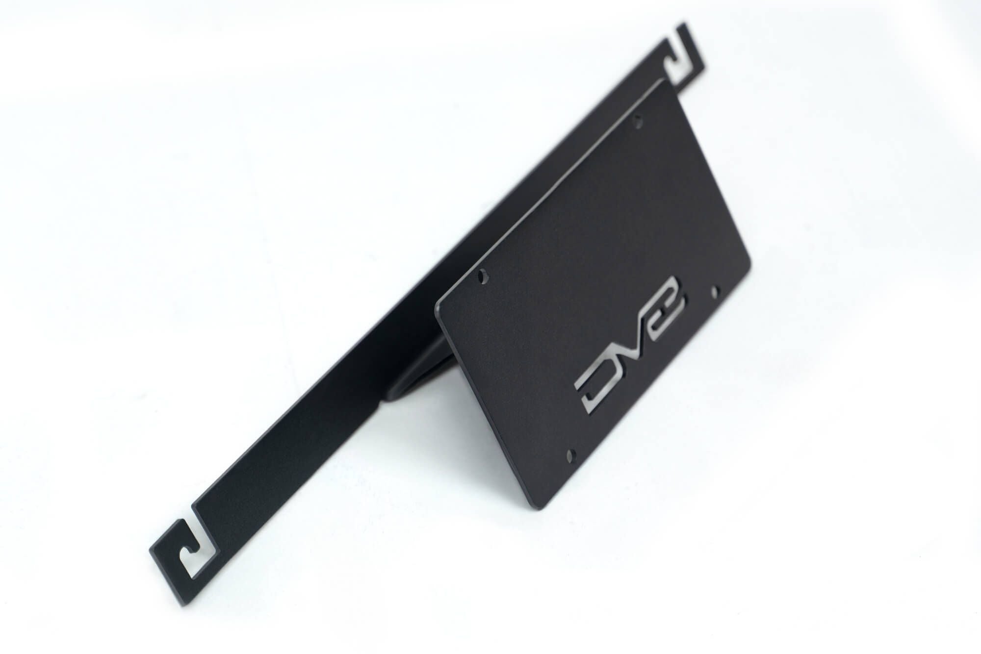 DV8 Offroad license plate mount 3/4 angle view showing bracket arm and mounting structure
