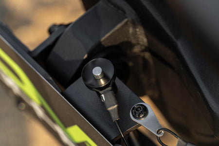 DV8 Offroad universal D-ring license plate mount close-up detail showing stainless steel ball bearing quick-release pin