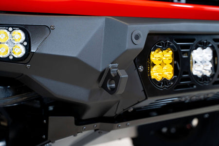 Addictive Desert Designs Bomber Baja front bumper close-up showing amber and white light pods on bumper corner