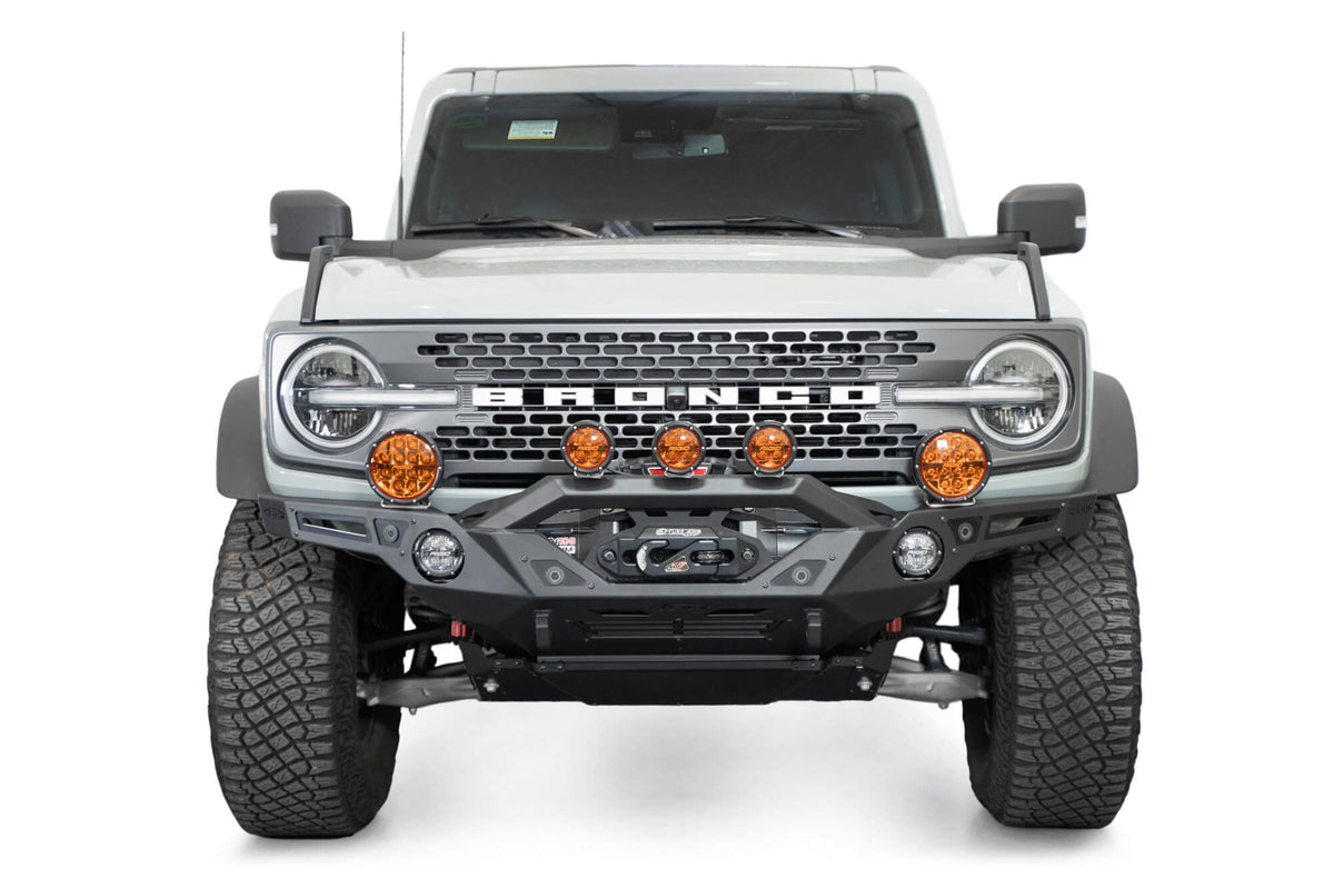 Addictive Desert Designs Krawler front bumper installed on gray Ford Bronco with amber marker lights, straight-on front view