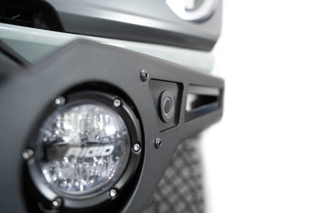 Addictive Desert Designs Krawler front bumper installed on gray Ford Bronco, close-up showing headlight and bumper corner