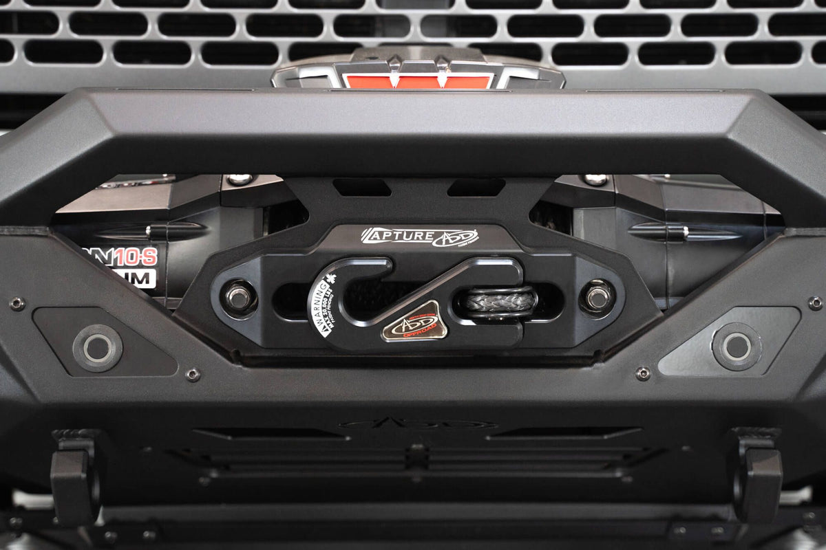 Addictive Desert Designs Krawler front bumper installed on gray Ford Bronco, straight-on close-up showing winch mount and bumper center