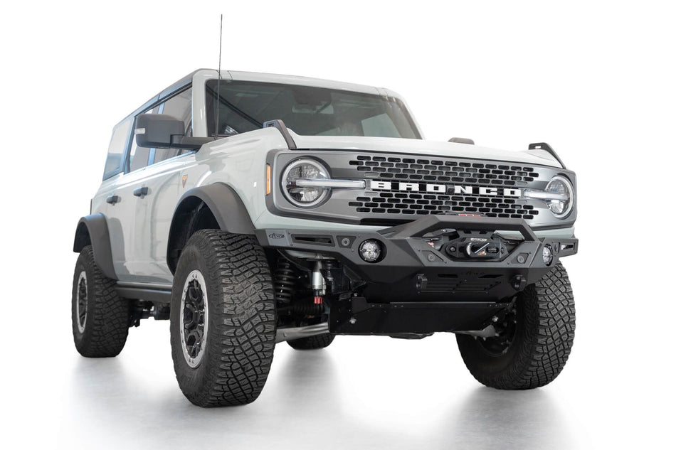 Addictive Desert Designs Krawler front bumper installed on gray Ford Bronco, front three-quarter view product shot on white background