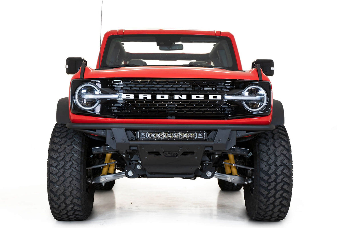 Addictive Desert Designs PRO Bolt-On front bumper installed on red Ford Bronco, straight-on front view product shot on white background, alternate angle