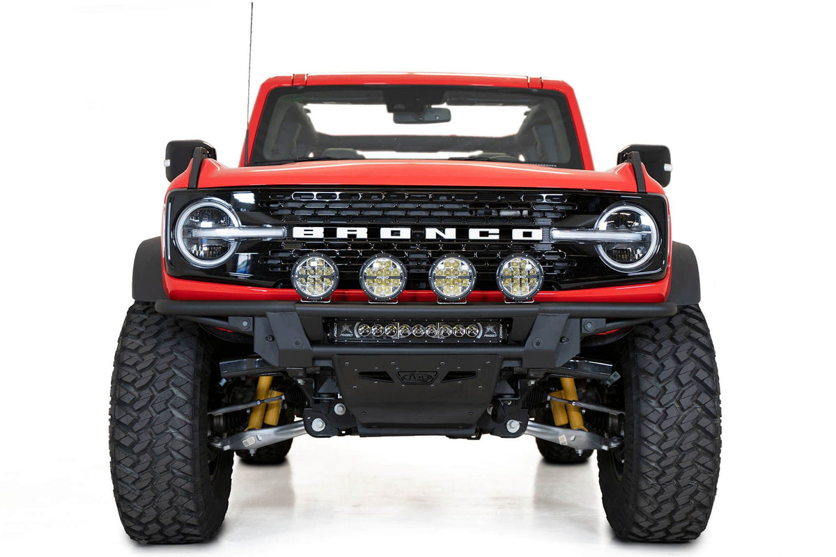 Addictive Desert Designs PRO Bolt-On front bumper installed on red Ford Bronco, straight-on front view product shot on white background