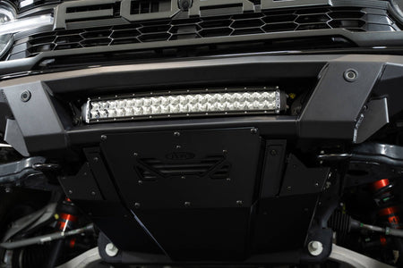 Addictive Desert Designs Phantom front bumper installed on black Ford Bronco Raptor, straight-on close-up showing light bar and bumper center