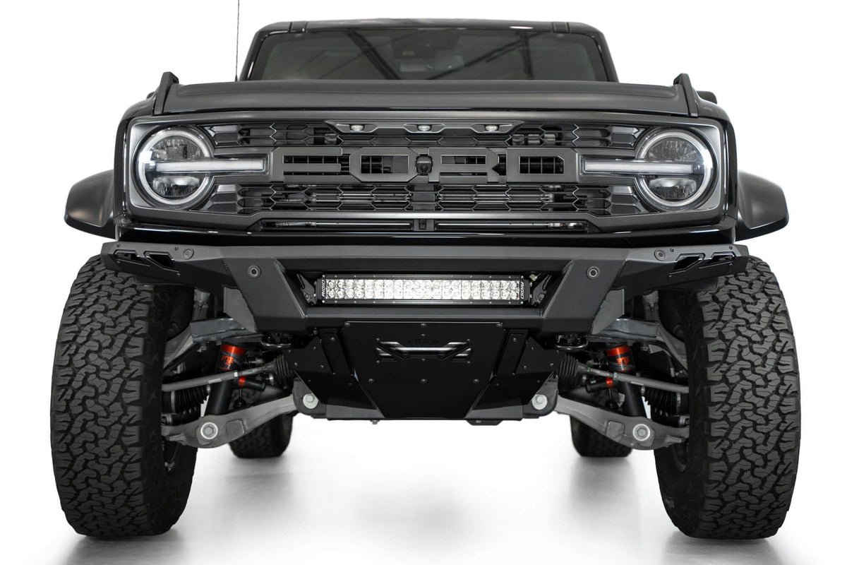 Addictive Desert Designs Phantom front bumper installed on black Ford Bronco Raptor, straight-on front view, product shot on white background