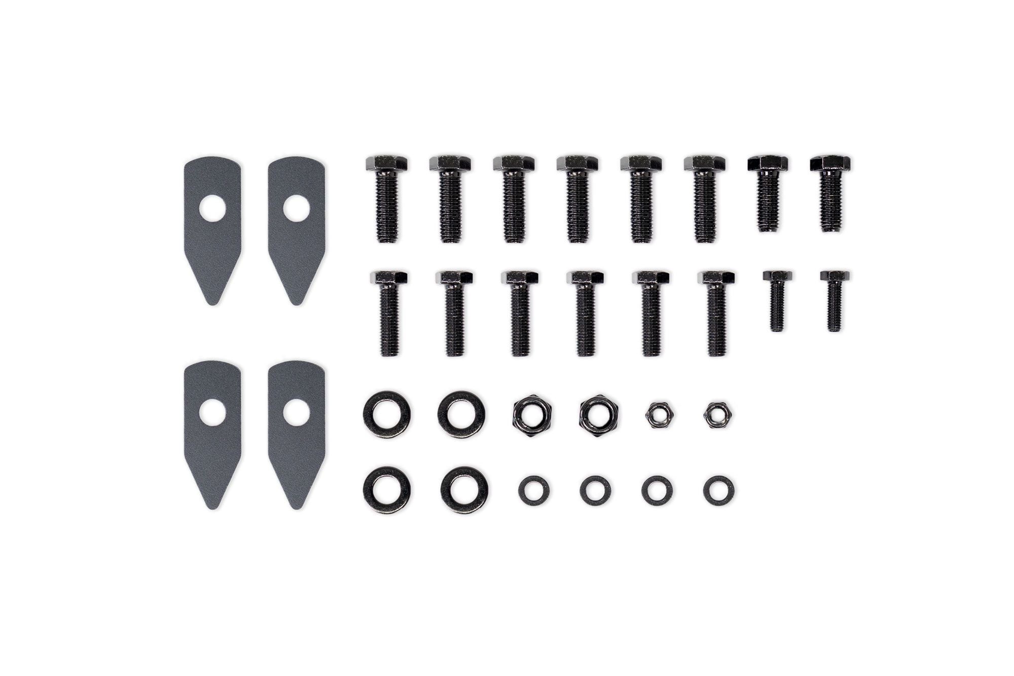 Set of black screws, washers, and other fasteners on a white background