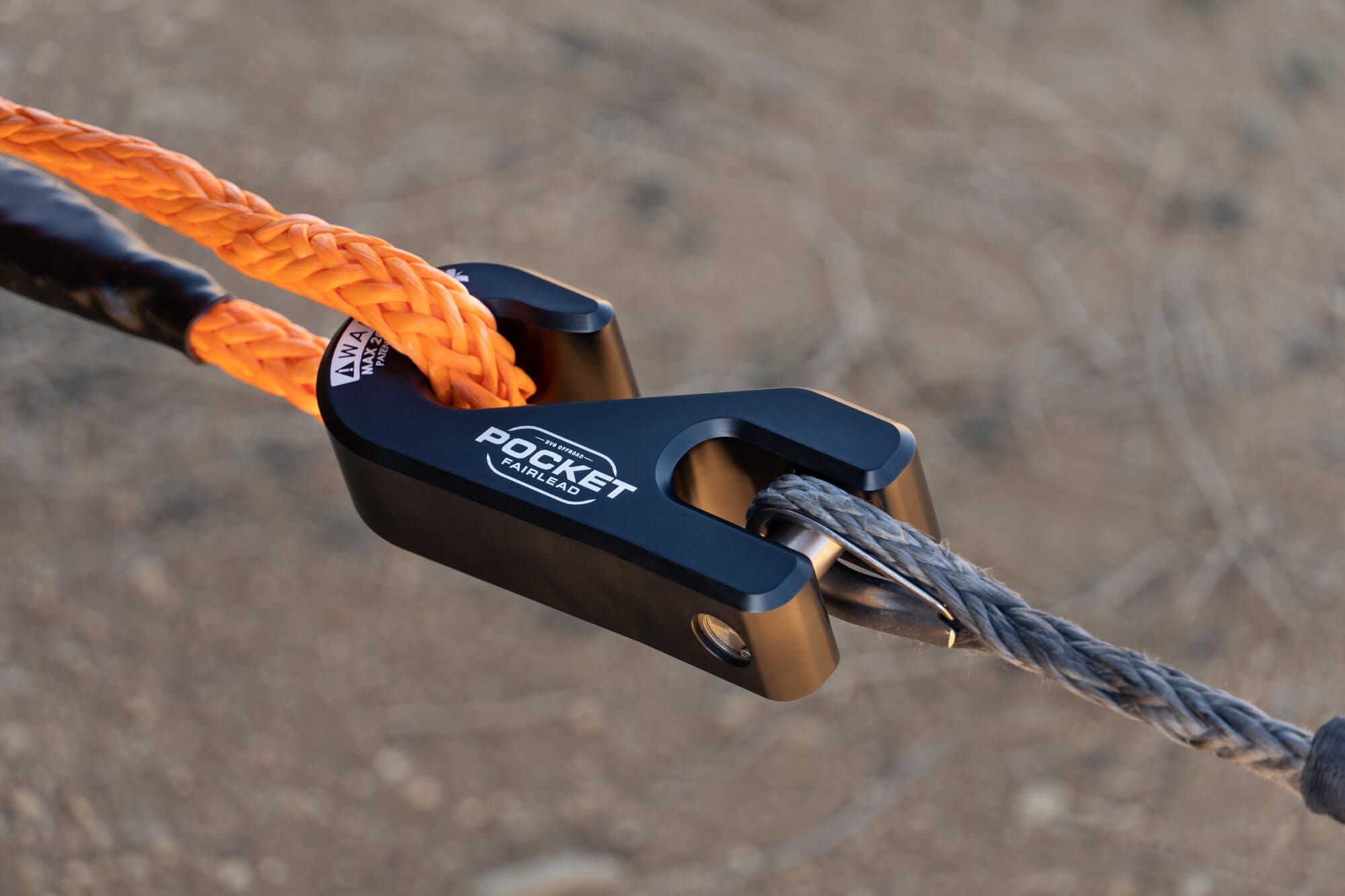 Fairlead with a grey rope hooked around an orange rope