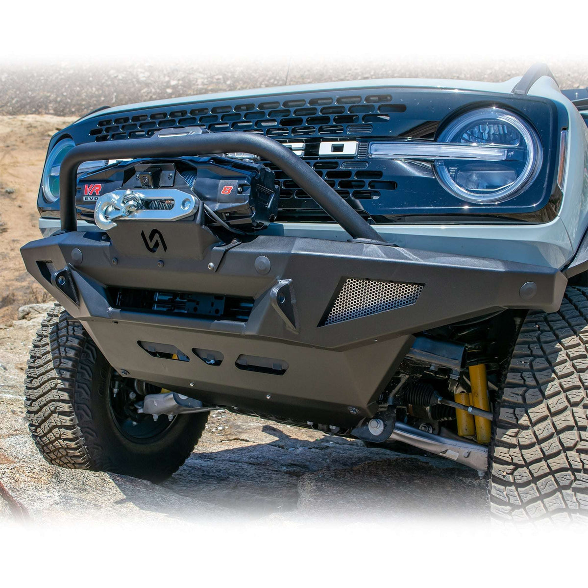 Turn Offroad winch front bumper package installed on Ford Bronco, front three-quarter close-up showing skid plate and bull bar