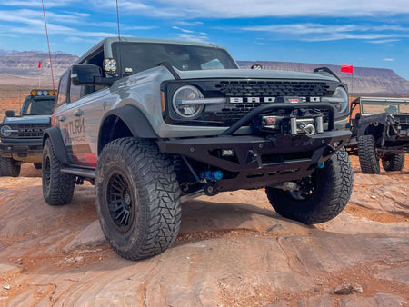 Turn Offroad winch front bumper package installed on Ford Bronco, distant front three-quarter view on desert trail