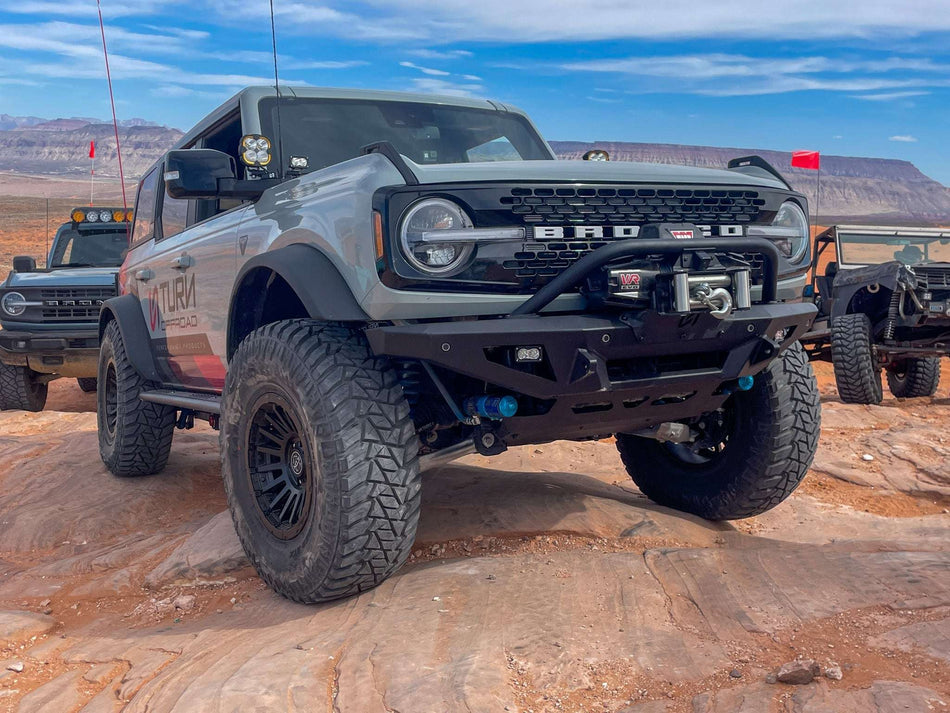 Turn Offroad winch front bumper package installed on Ford Bronco, distant front three-quarter view on desert trail