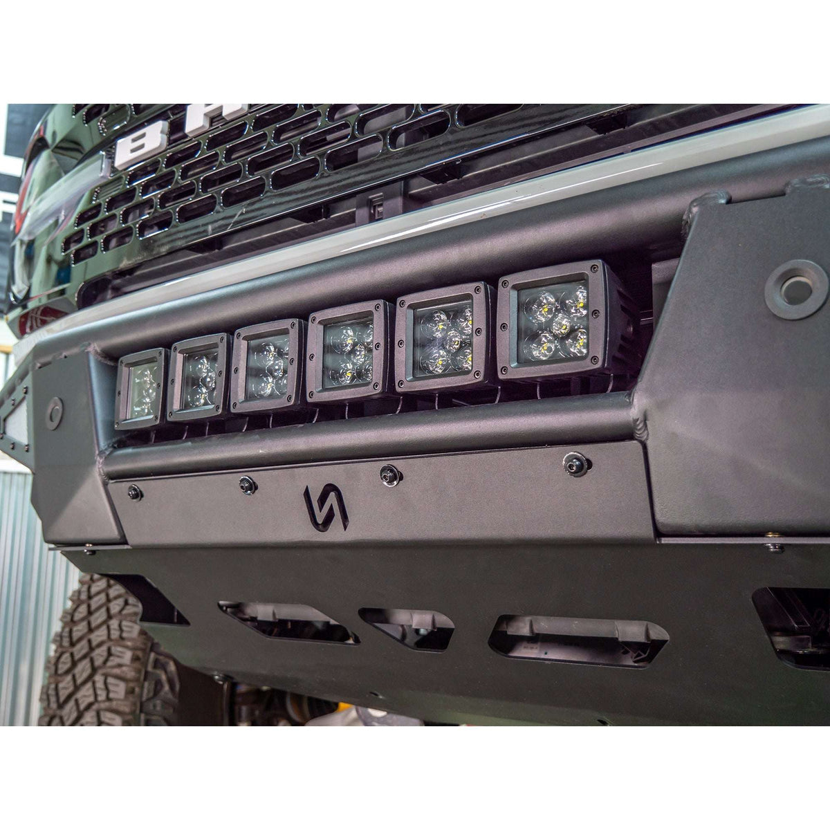 Turn Offroad Baja front bumper and skid plate installed on Ford Bronco, close-up showing light bar mounted on bumper