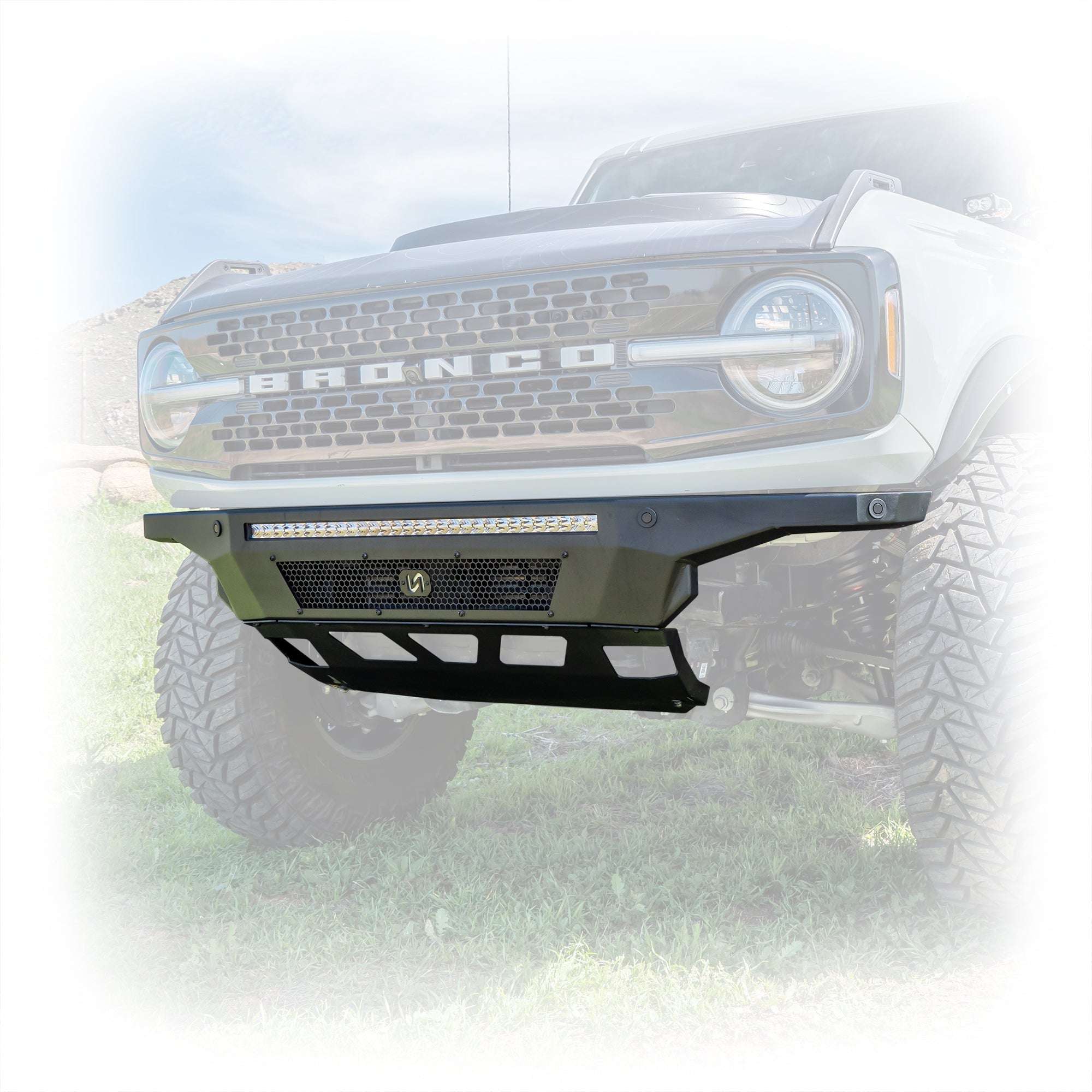 Turn Offroad Hyperlyte front bumper installed on olive green Ford Bronco, close-up front three-quarter view showing integrated light bar