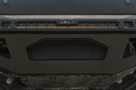 DV8 Offroad front bumper compatible with FBBO-01 fairlead cover plate, underside close-up showing skid plate and light bar cutout