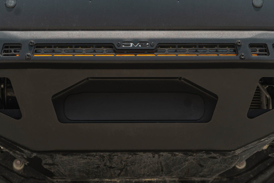 DV8 Offroad front bumper compatible with FBBO-01 fairlead cover plate, underside close-up showing skid plate and light bar cutout