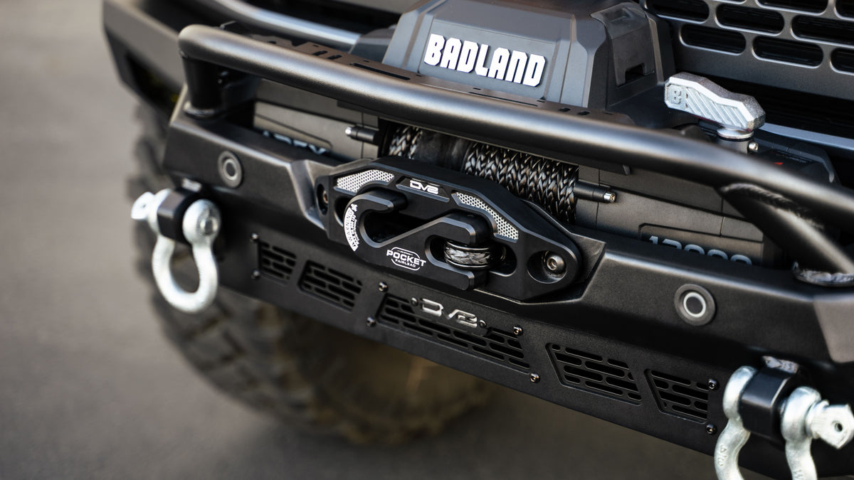 DV8 Offroad Spec Series winch front bumper installed on Ford Bronco Badlands, close-up showing winch mount and bumper center
