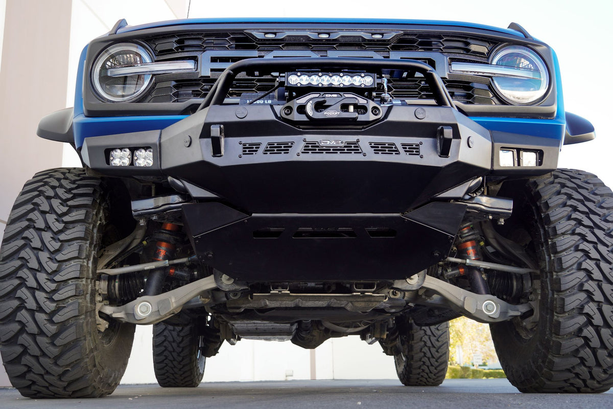DV8 Offroad Spec Series winch front bumper installed on gray Ford Bronco, straight-on front close-up showing light bar