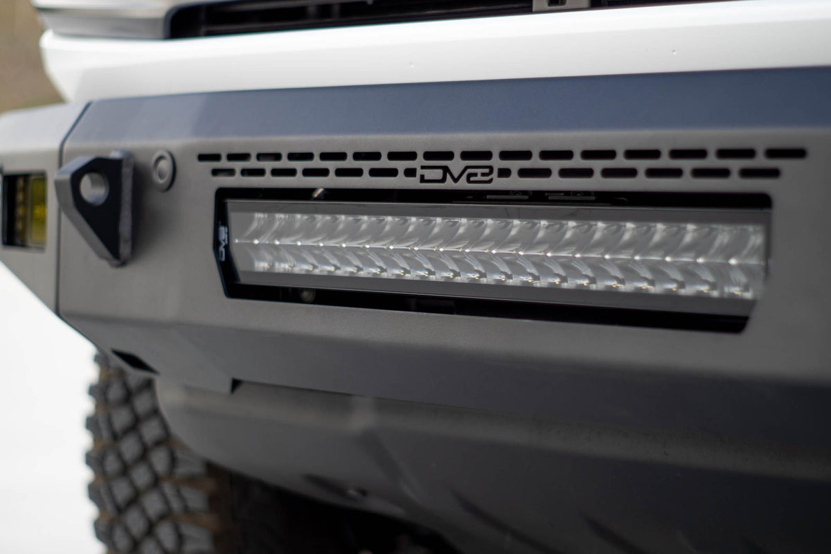 DV8 Offroad OE Plus Series V2 front bumper installed on gray Ford Bronco, close-up showing light bar and wheel
