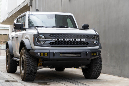 DV8 Offroad OE Plus Series V2 front bumper installed on white Ford Bronco, front three-quarter view in urban lot