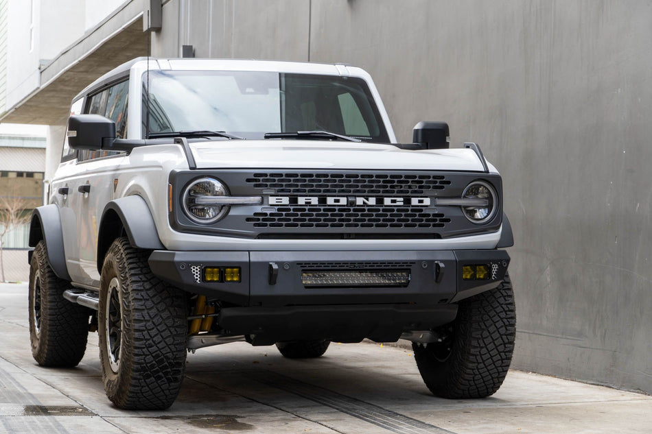 DV8 Offroad OE Plus Series V2 front bumper installed on white Ford Bronco, front three-quarter view in urban lot
