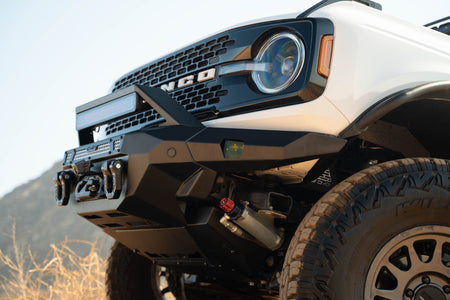 DV8 Offroad FBBR-07 MTO V2 front bumper installed on white Ford Bronco – close-up front view showing bull bar