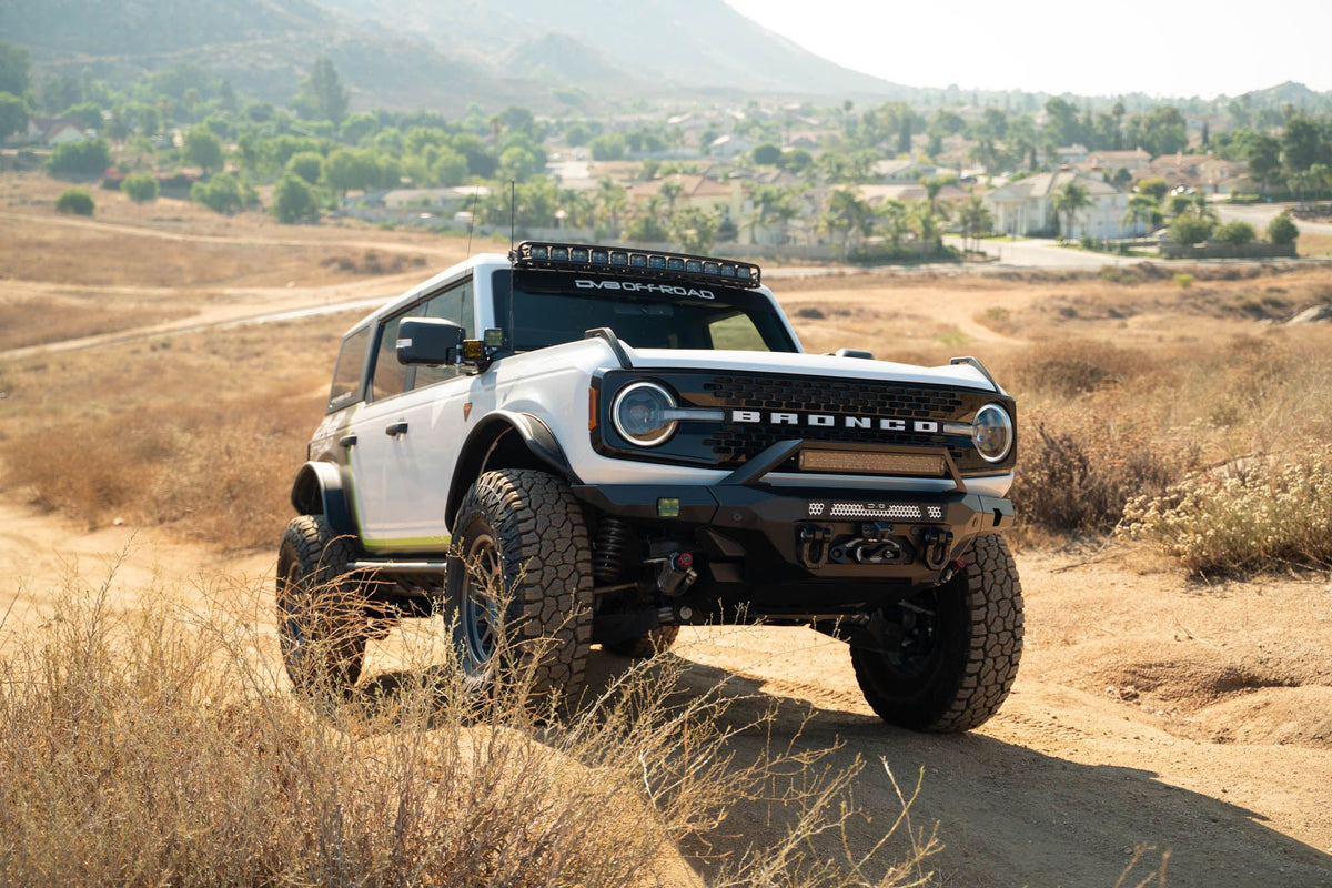 DV8 Offroad FBBR-07 MTO V2 front bumper installed on white Ford Bronco – desert trail front view