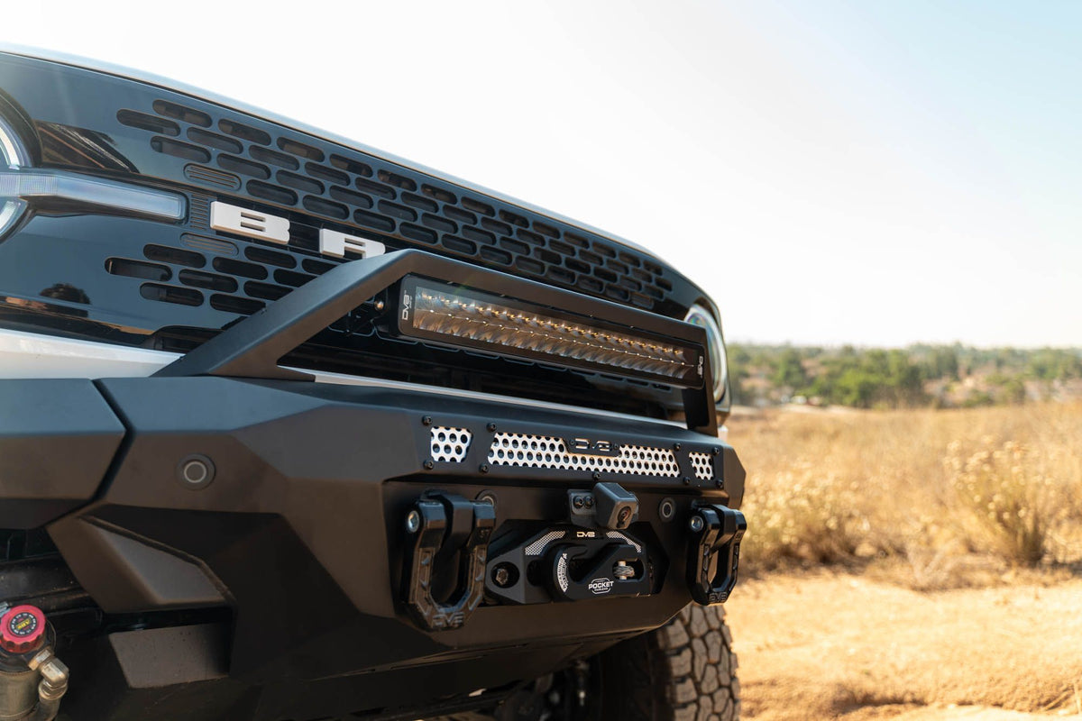 DV8 Offroad FBBR-07 MTO V2 front bumper installed on dark Ford Bronco – front three-quarter desert terrain