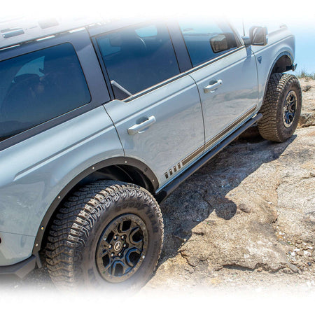 Turn Offroad fender delete kit installed on 4-door Ford Bronco, full side profile view on rock terrain