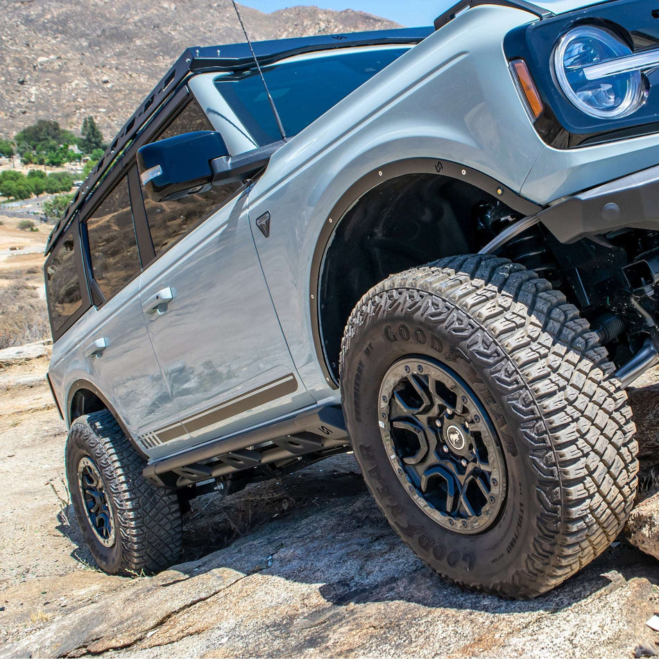 Turn Offroad fender delete kit installed on Ford Bronco, front three-quarter close-up on rock terrain
