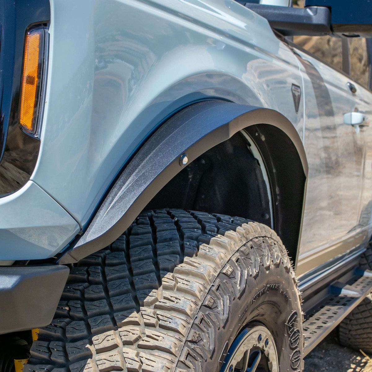 Turn Offroad steel fender flares installed on Ford Bronco, close-up front fender flare and wheel with turn signal visible