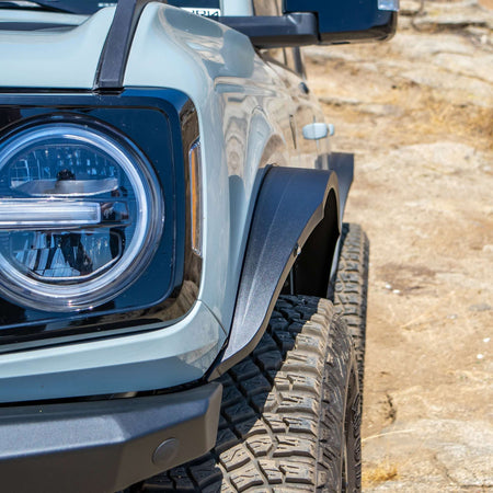 Turn Offroad steel fender flares installed on Ford Bronco, close-up headlight and front fender flare