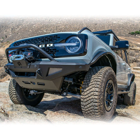 Turn Offroad steel fender flares installed on Ford Bronco, front close-up showing bumper and fender flare on rocky terrain